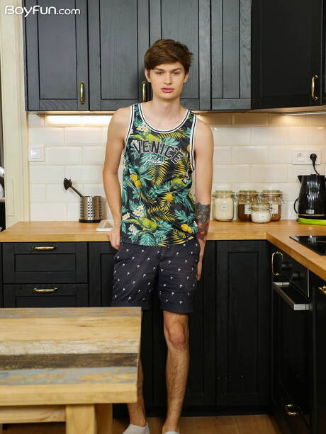 Young boy Curtis Cameron posing naked in the kitchen